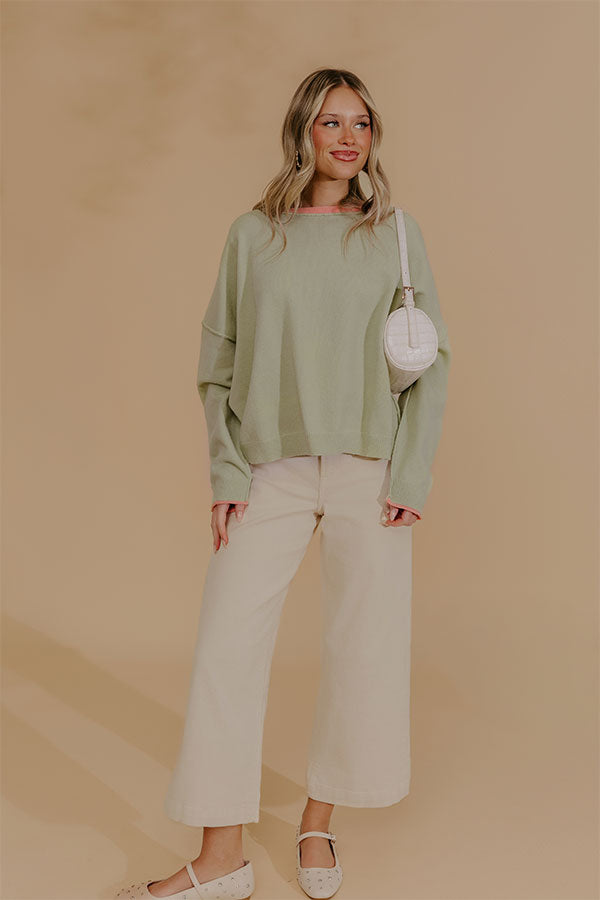 Oversized Knit Top with Coral Accents and Exposed Seam Detailing