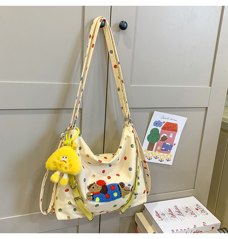 Polka Dot Crossbody Bag with Plush Toy Attachment and Adjustable Strap