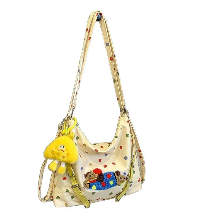 Polka Dot Crossbody Bag with Plush Toy Attachment and Adjustable Strap