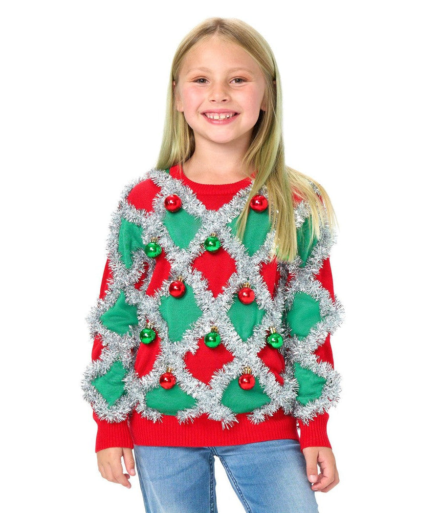 Girl wearing a festive sweater with red and green decorations on a white background