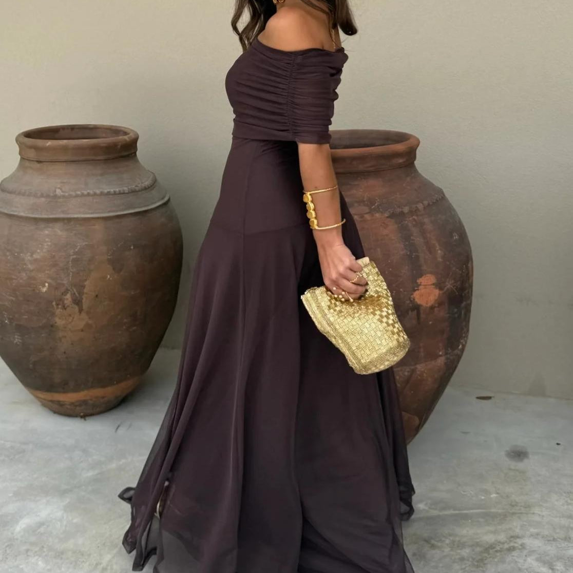 Stylish brown off-shoulder maxi dress for women, a perfect elegant wedding guest or evening party outfit.