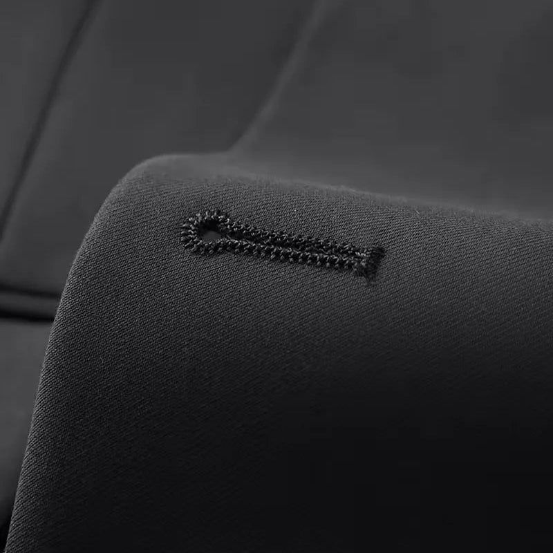 Close-up of the double-breasted jacket and waistcoat of a men's slim fit 3-piece suit.