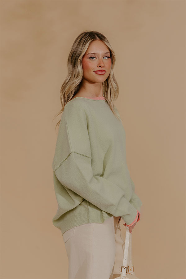 Oversized Knit Top with Coral Accents and Exposed Seam Detailing