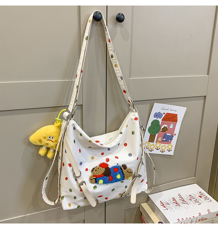 Polka Dot Crossbody Bag with Plush Toy Attachment and Adjustable Strap