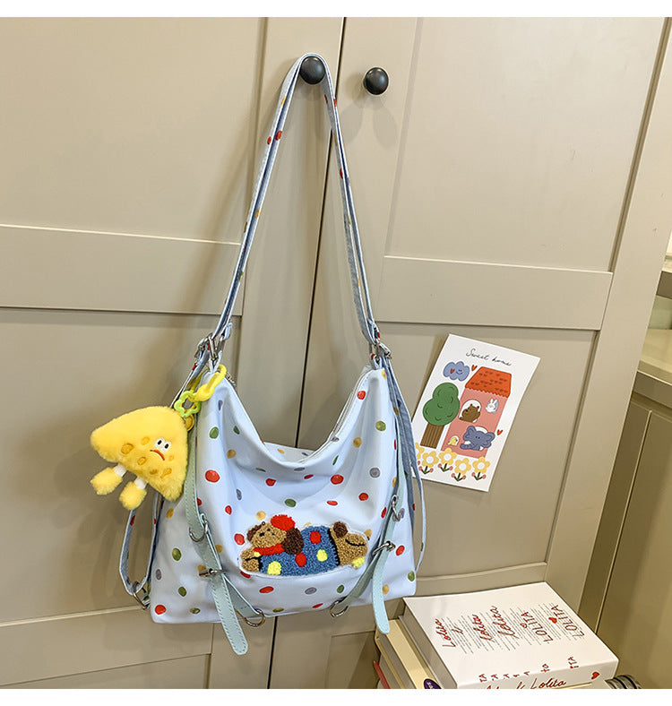 Polka Dot Crossbody Bag with Plush Toy Attachment and Adjustable Strap