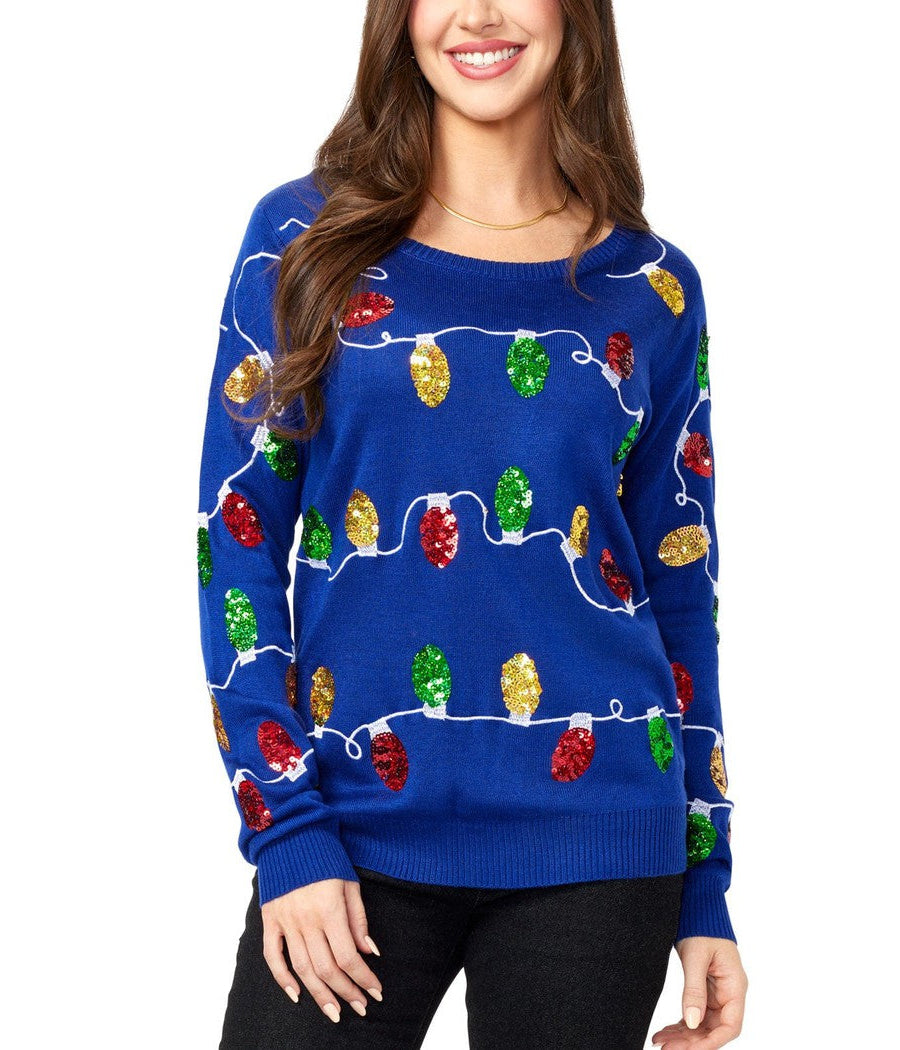 Woman wearing a blue sweater with colorful Christmas lights and trees design on a white background