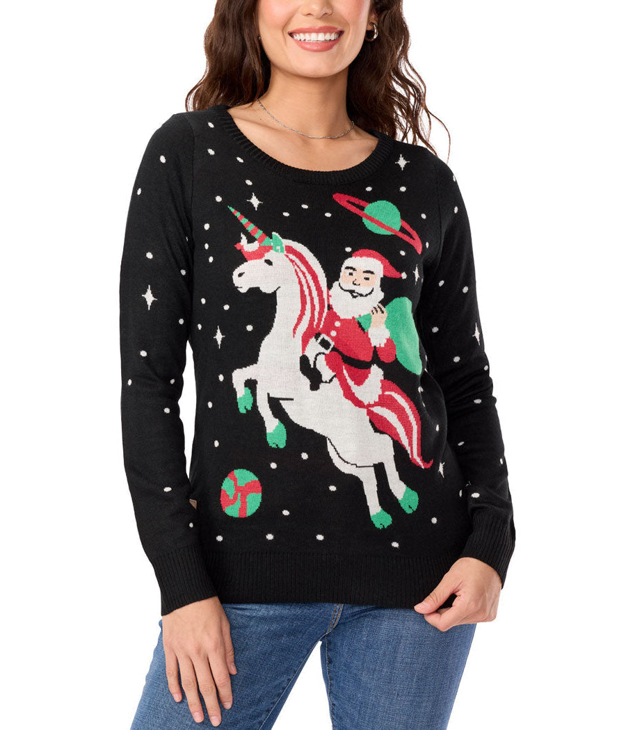 Woman wearing a black sweater with a festive design of Santa riding a unicorn on a white background
