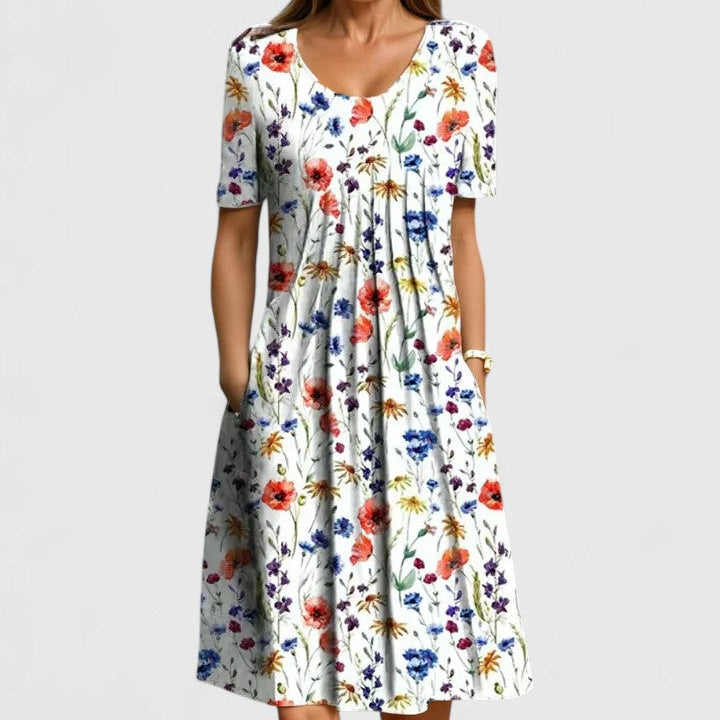 Chic women's short sleeve floral midi dress, perfect for summer. Features a comfortable fit, elegant print, and convenient pockets.