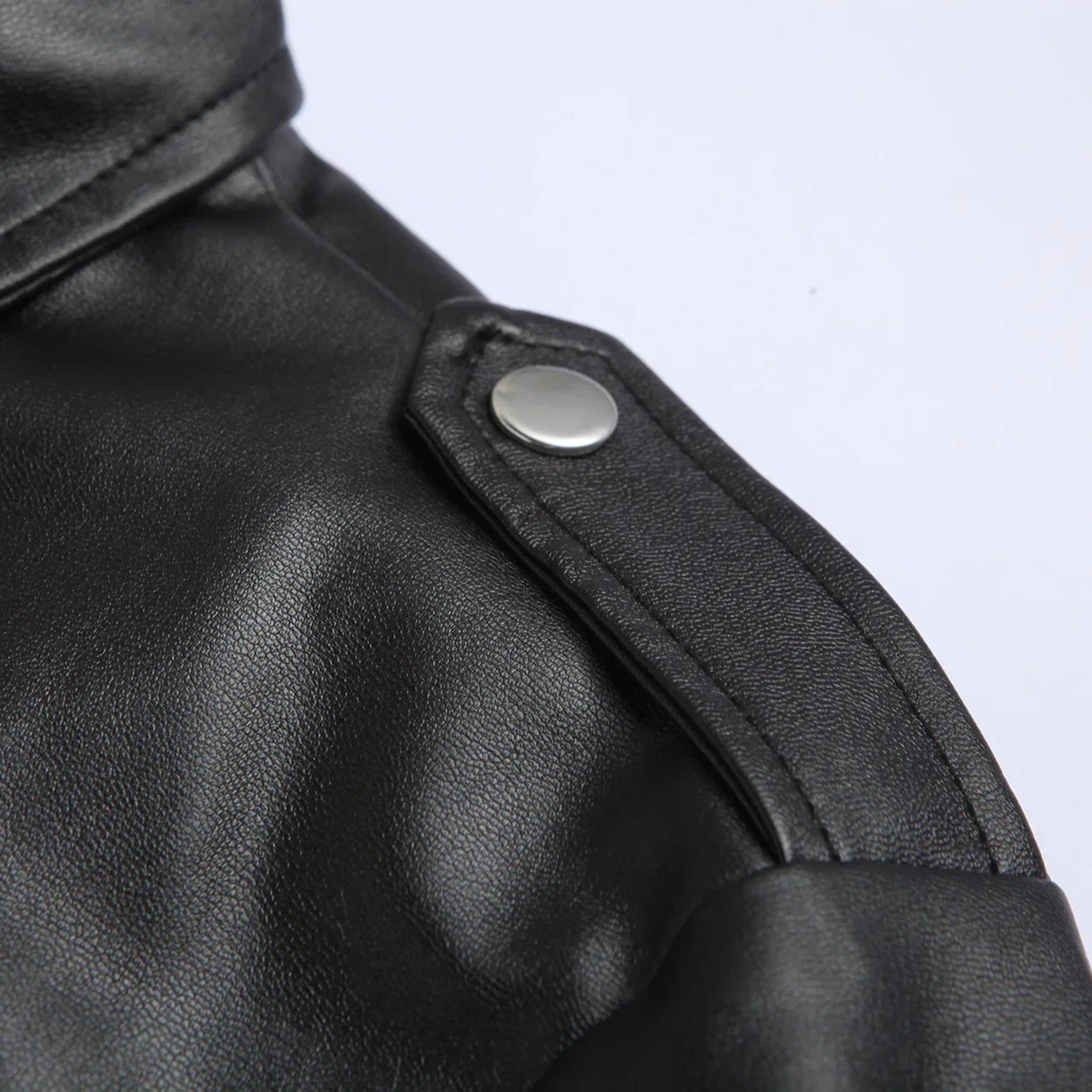 Close-up of a men's stylish bomber jacket showcasing the belted hem detail and functional zippered pockets. Modern design.