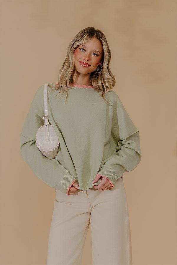 Oversized Knit Top with Coral Accents and Exposed Seam Detailing